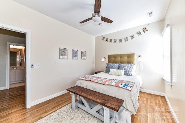 bedroom featuring wood-type flooring, sink, and ceiling fan