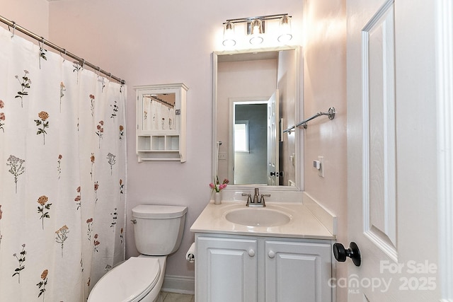 bathroom featuring vanity and toilet