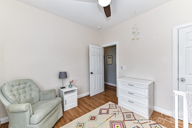 sitting room featuring ceiling fan and light hardwood / wood-style floors