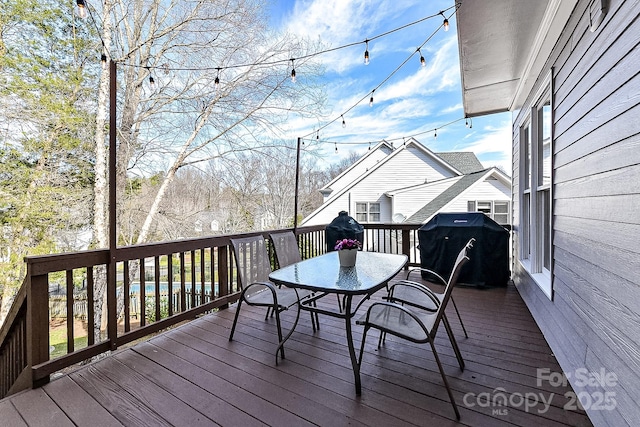 wooden deck with a grill