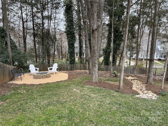 view of yard with an outdoor fire pit