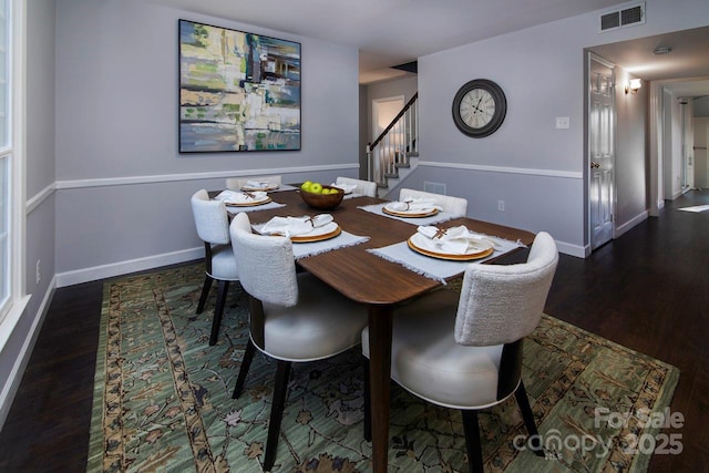 dining room with dark hardwood / wood-style flooring