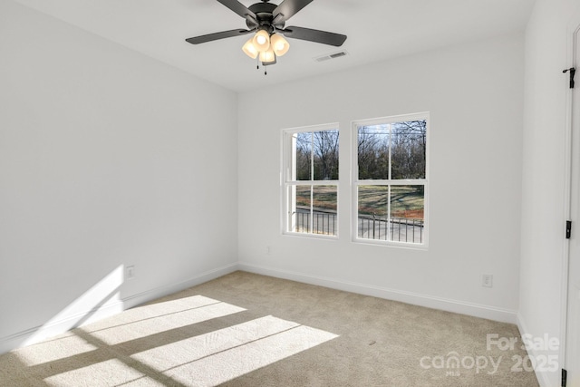 empty room featuring light colored carpet and ceiling fan