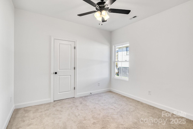 carpeted spare room with ceiling fan