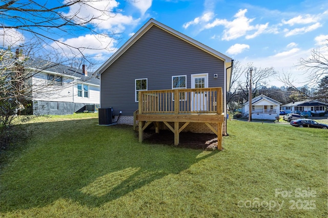 back of house featuring a deck, central AC unit, and a lawn