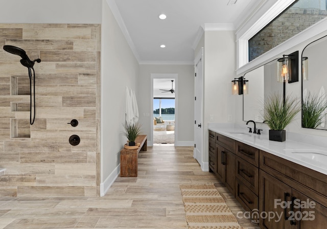 bathroom with vanity, ceiling fan, crown molding, a shower, and wood-type flooring