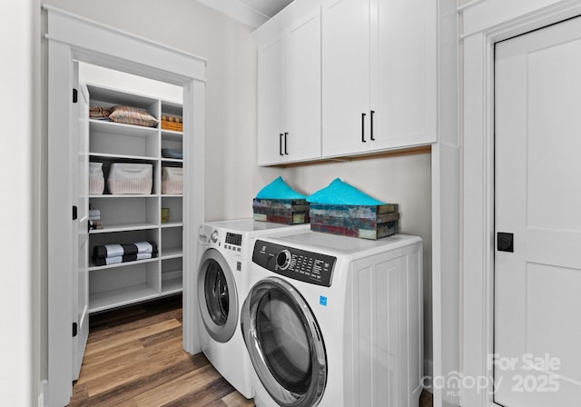 laundry area with cabinets, dark hardwood / wood-style flooring, and separate washer and dryer