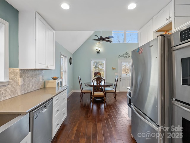 kitchen featuring dark wood-style floors, stainless steel appliances, light countertops, backsplash, and white cabinets