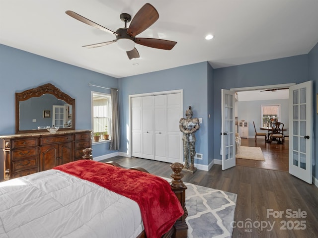 bedroom featuring a closet, dark wood-type flooring, french doors, and ceiling fan