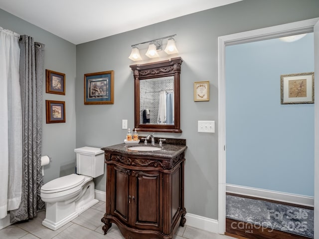 bathroom featuring vanity, tile patterned floors, and toilet