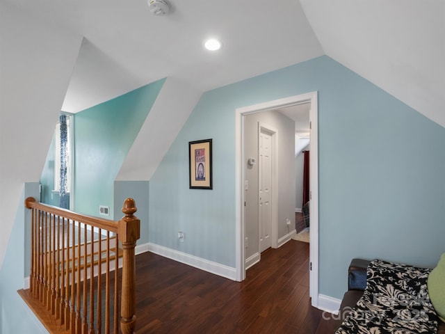 bonus room featuring lofted ceiling, visible vents, baseboards, and wood finished floors