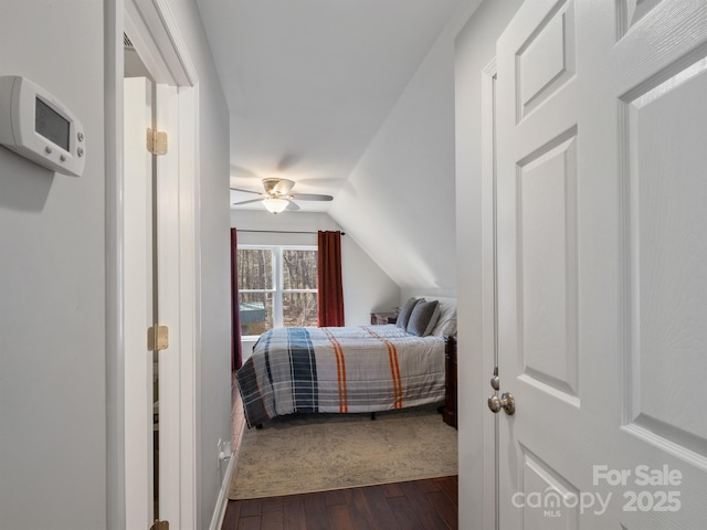 bedroom featuring a ceiling fan, dark wood-style flooring, and vaulted ceiling