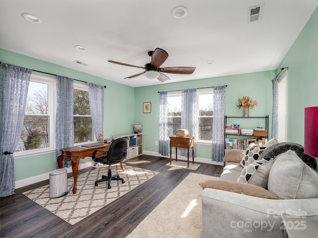 home office featuring plenty of natural light, dark wood-type flooring, and ceiling fan