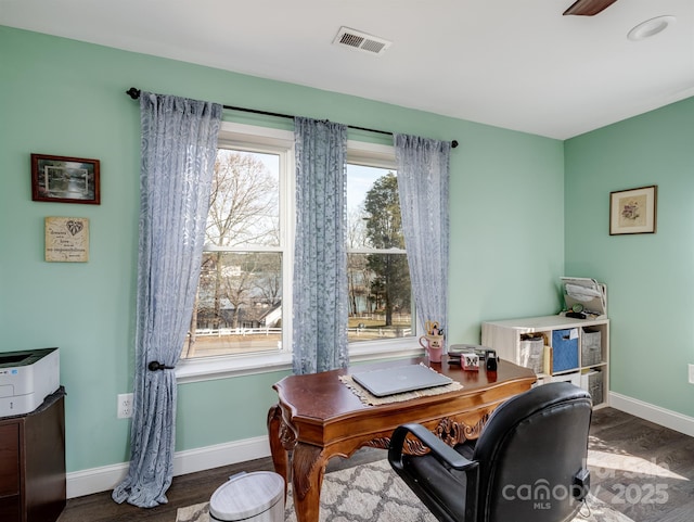 office space featuring wood finished floors, visible vents, and baseboards