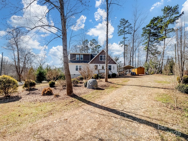 view of front of property with crawl space and dirt driveway