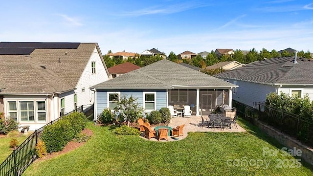 rear view of property with a sunroom, a lawn, and a patio