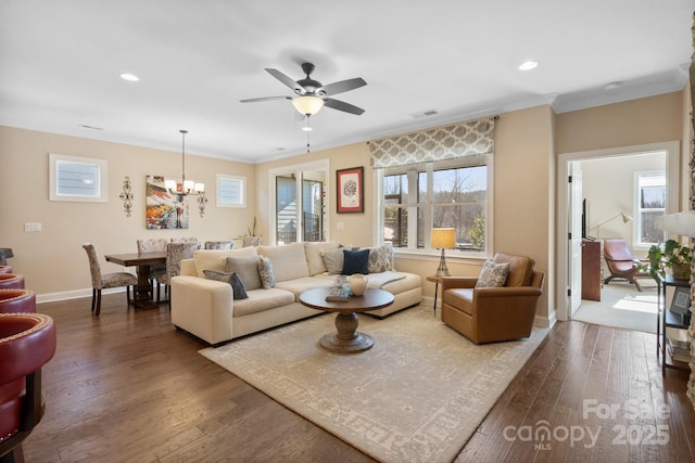 living room with crown molding, ceiling fan with notable chandelier, and hardwood / wood-style flooring