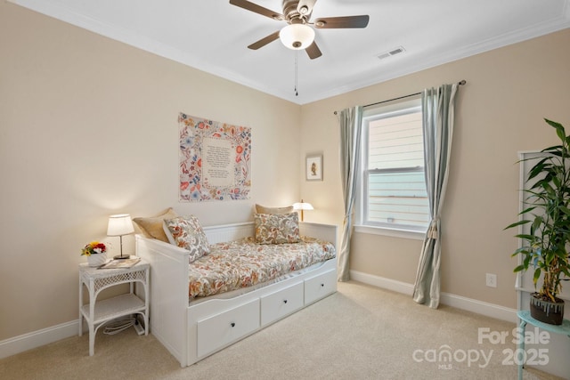 bedroom featuring ceiling fan, ornamental molding, and light colored carpet