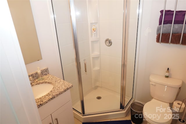 bathroom with walk in shower, vanity, and toilet