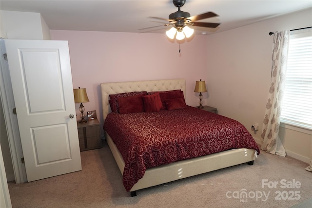 bedroom featuring carpet flooring, multiple windows, and ceiling fan