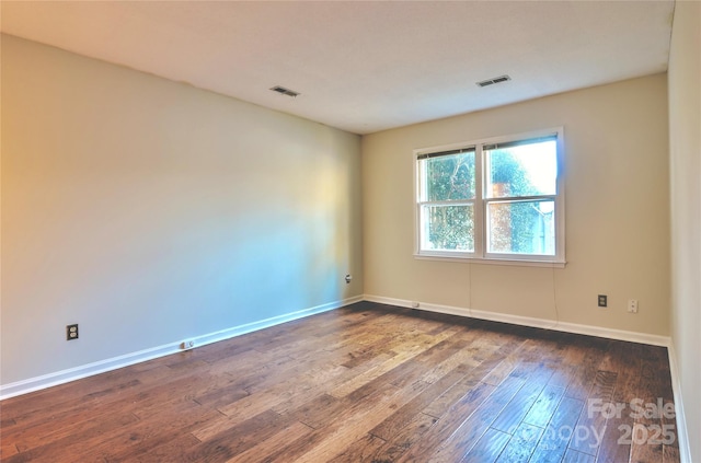 spare room with dark hardwood / wood-style floors