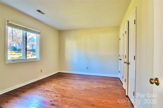 unfurnished room featuring hardwood / wood-style flooring