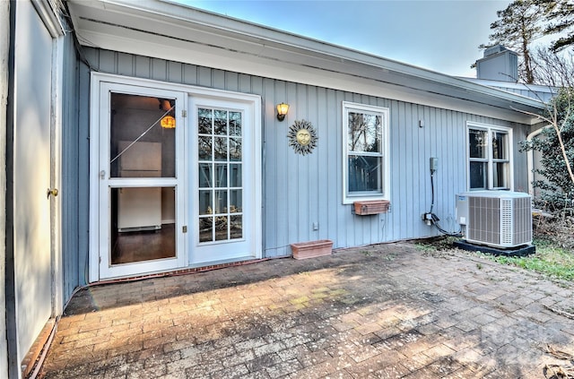 property entrance featuring cooling unit and a patio