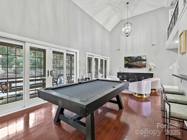 recreation room with hardwood / wood-style flooring, billiards, a notable chandelier, french doors, and high vaulted ceiling