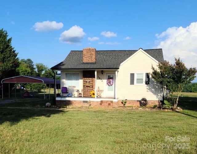 view of front facade with a front yard and a carport