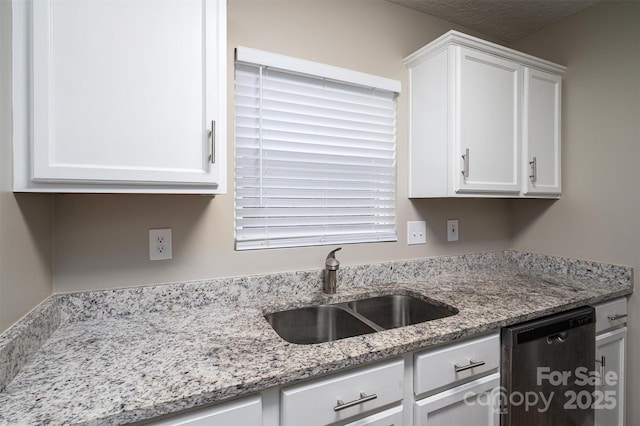 kitchen featuring a textured ceiling, dishwasher, white cabinetry, sink, and light stone counters