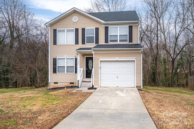 view of property with a front yard and a garage