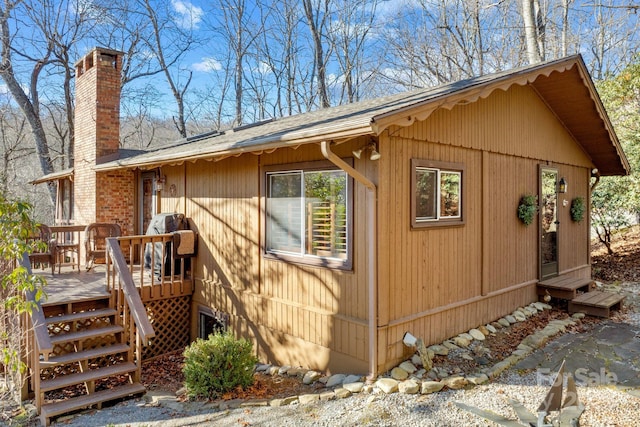 view of side of property featuring a wooden deck