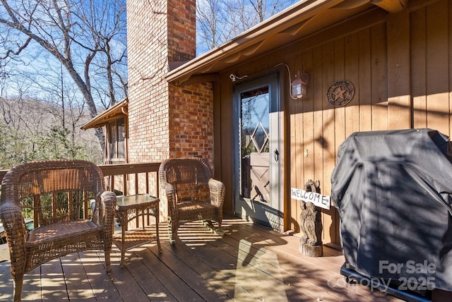 wooden terrace featuring a grill