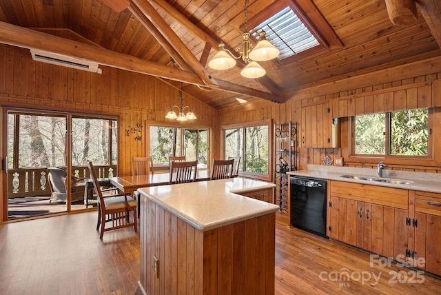 kitchen with a skylight, sink, decorative light fixtures, an inviting chandelier, and black dishwasher