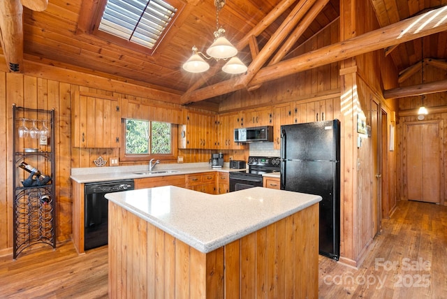 kitchen with sink, a center island, light hardwood / wood-style flooring, lofted ceiling with beams, and black appliances