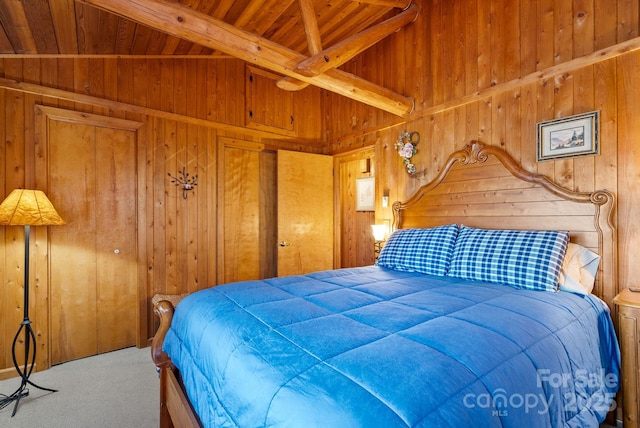 carpeted bedroom with lofted ceiling with beams, wooden walls, and wood ceiling