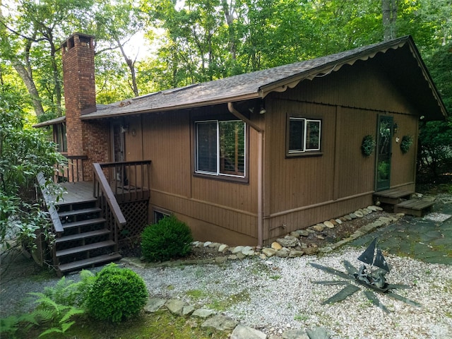 44 Yanequa Way, Brevard, NC 28712 - view of property exterior featuring a chimney, a deck, stairway, and roof with shingles