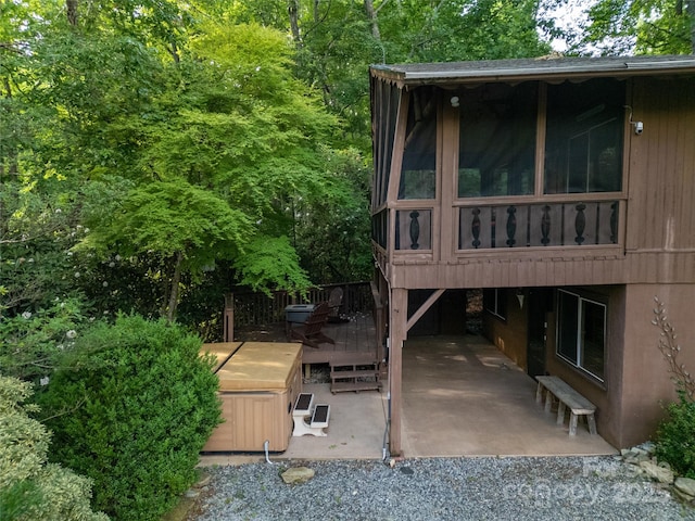 44 Yanequa Way, Brevard, NC 28712 - view of property exterior with a patio, a deck, a hot tub, and a sunroom