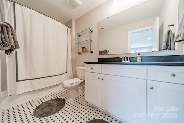 full bathroom with tile patterned floors, vanity, shower / tub combo, and toilet