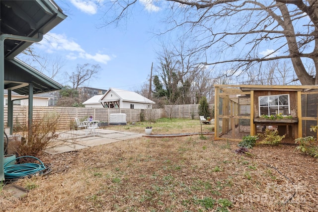 view of yard with a patio, an outdoor structure, and fence