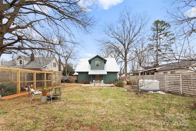 view of yard featuring an outdoor structure, a fenced backyard, and exterior structure