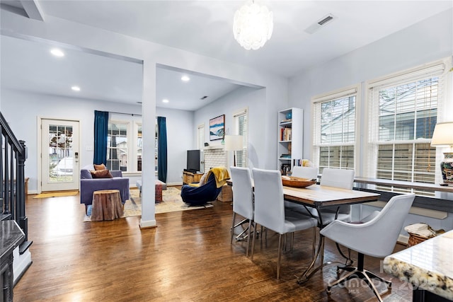 dining area with recessed lighting, baseboards, a notable chandelier, and wood finished floors