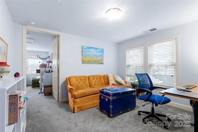 carpeted office space with visible vents and baseboards