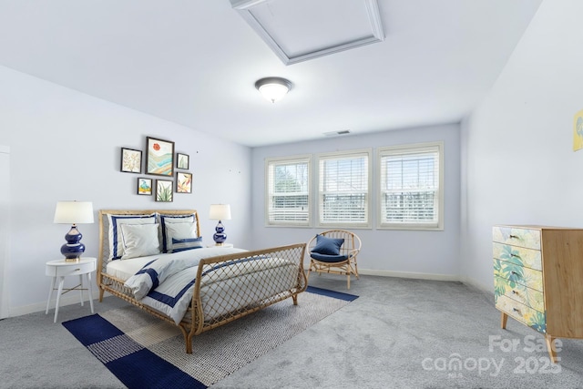 bedroom with attic access, carpet flooring, and baseboards