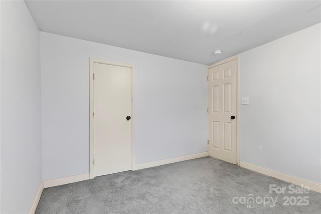 carpeted spare room with baseboards