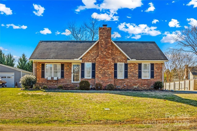 view of front of house with a front lawn, an outdoor structure, and a garage