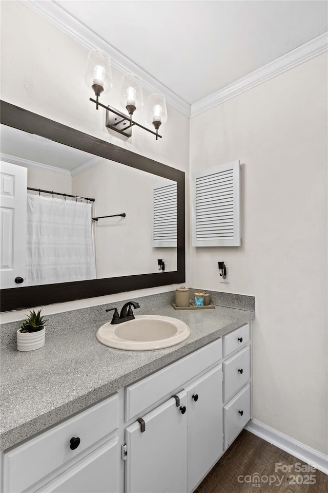 bathroom featuring hardwood / wood-style floors, vanity, and crown molding