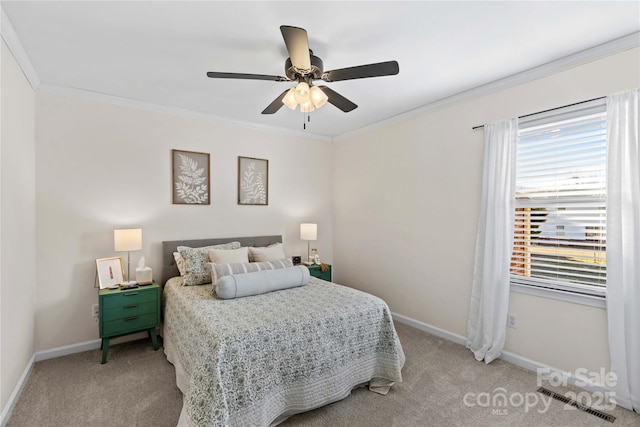 bedroom with carpet flooring, ceiling fan, and crown molding