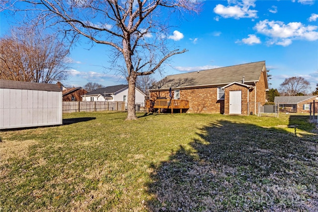 view of yard featuring a shed and a wooden deck