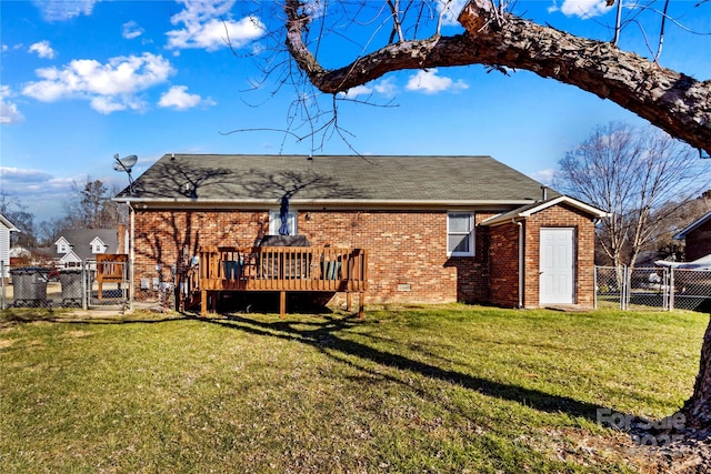 back of house featuring a lawn and a deck